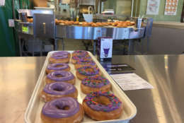 Krispy Kreme is selling donuts with purple frosting to raise awareness for National Domestic Violence Awareness Month. Customers who buy a purple-frosted donut will also be given a card with information about how victims can get help. (WTOP/John Aaron)