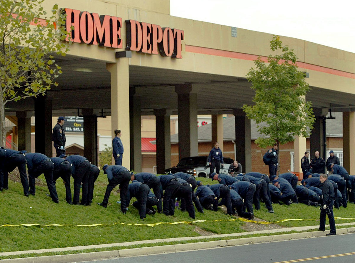 Fairfax County, Va. Police search for clues in a sniper shooting outside a Home Depot in Falls Church, Va. Tuesday, Oct. 15, 2002. Ballistics evidence links the death of a woman shot in a suburban parking lot to the Washington-area sniper, and authorities said Tuesday they were confident that detailed witness accounts from the scene would lead them to the person who has now killed nine people.  (AP Photo/Doug Mills)