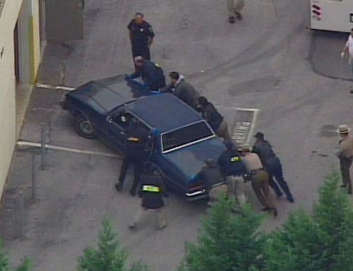 In this view from WJZ-TV video, the car in which two men were arrested at a Maryland roadside rest stop early Thursday, Oct. 24, 2002, is pushed into a facility in Rockville, Md, after being transported from the rest area.  The two were wanted for questioning in the three-week wave of deadly sniper attacks that have terrorized the Washington, D.C. area. (AP Photo/courtesy WJZ-TV)