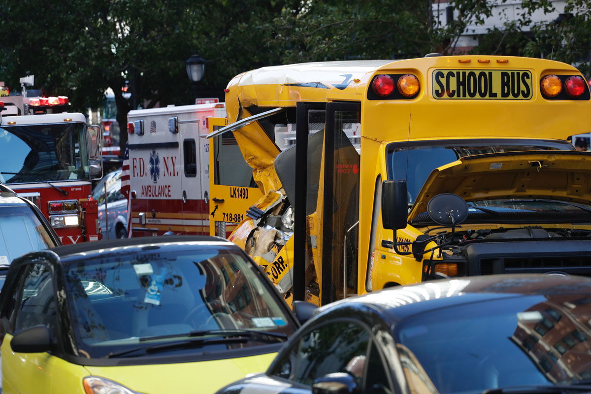 Authorities respond near a damaged school bus Tuesday, Oct. 31, 2017, in New York. A motorist drove onto a busy bicycle path near the World Trade Center memorial and struck several people on Tuesday police and witnesses said. (AP Photo/Mark Lennihan)