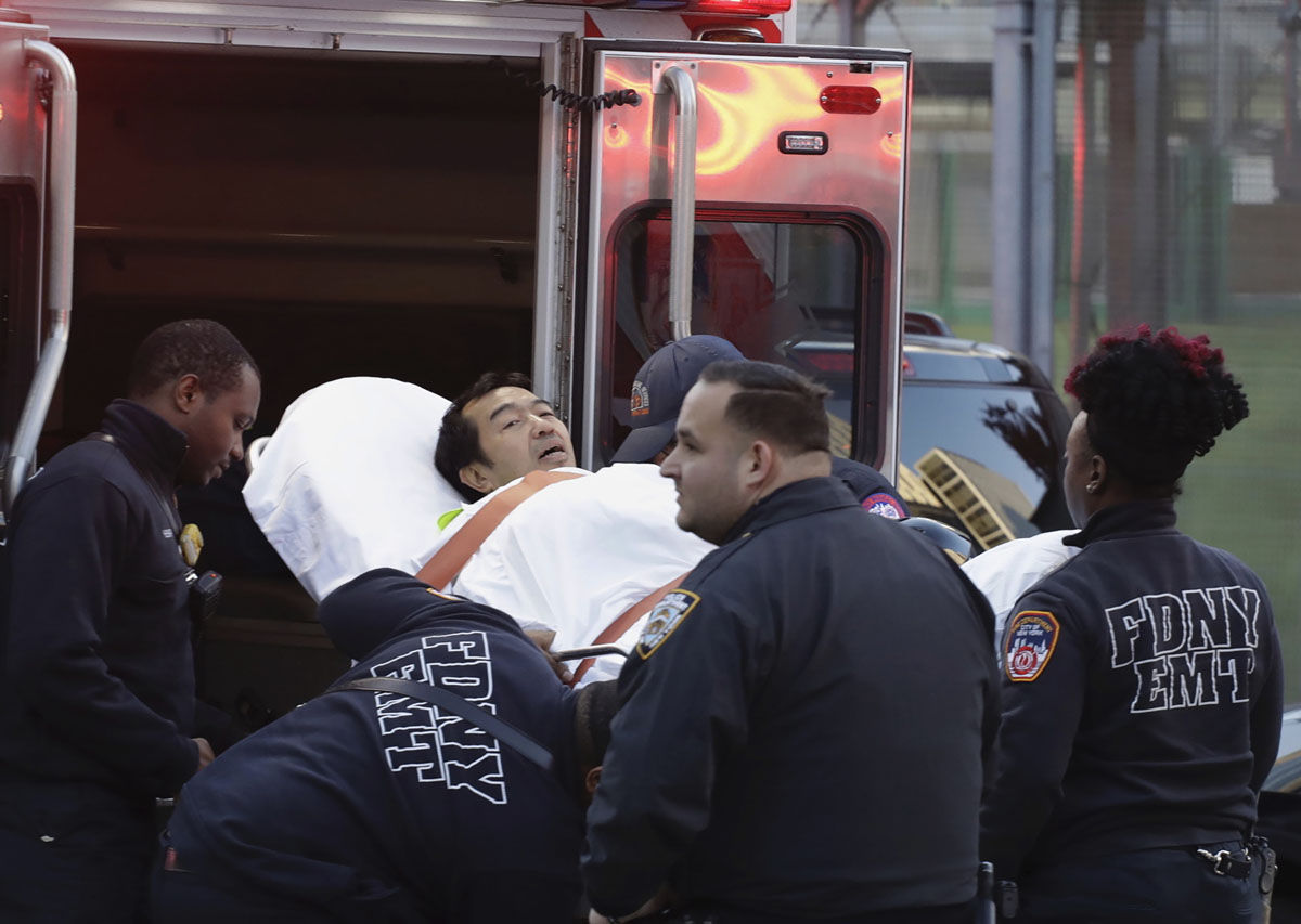 Emergency personnel carry a man into an ambulance after a motorist drove onto a busy bicycle path near the World Trade Center memorial and struck several people Tuesday, Oct. 31, 2017, in New York. (AP Photo/Mark Lennihan)