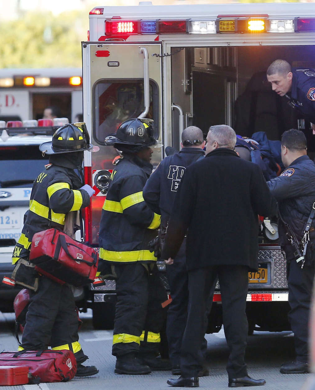 Paramedics lift an individual into an ambulance near the scene after reports of a deadly shooting Tuesday Oct. 31, 2017, in New York. A motorist drove onto a busy bicycle path near the World Trade Center memorial and struck several people Tuesday, police and witnesses said. (AP Photo/Bebeto Matthews)