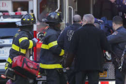 Paramedics lift an individual into an ambulance near the scene after reports of a deadly shooting Tuesday Oct. 31, 2017, in New York. A motorist drove onto a busy bicycle path near the World Trade Center memorial and struck several people Tuesday, police and witnesses said. (AP Photo/Bebeto Matthews)