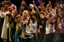 Michael Jackson, center, is joined by the featured performers of  "United We Stand: What More Can I Give?" benefit concert during the finale Sunday, Oct. 21, 2001, at RFK Stadium in Washington. Tens of thousands of music fans gathered Sunday to see an array of pop stars at the marathon concert celebrating America and raising money for victims of September's terrorist attacks. (AP Photo/Pablo Martinez Monsivais)