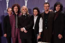 Tom Petty, third left, stands with his band the Heartbreakers after being inducted into the Rock and Roll Hall of Fame, Monday, March 18, 2002, at New York's Waldorf Astoria. (AP Photo/Ed Betz)
