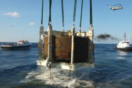 The turret of the Civil War ironclad USS Monitor is lifted out of the Atlantic Ocean off the coast of Hatteras, N.C., Monday, Aug 5, 2002.  The silt-packed turret was raised Monday from the Atlantic floor, nearly 140 years after the historic warship sank during a New Year's storm. (AP Photo/Steve Helber)