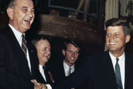 John F. Kennedy, at right,  stands with Lyndon Baines Johnson before the Texas delegation caucus in Los Angeles July 12, 1960 prior to the Democratic Convention.   Both Senators are Democratic contenders for the Presidential nomination.  Behind Senator Kennedy is his brother Robert F. Kennedy, his campaign manager.  Man behind Senator Johnson at left rear is unidentified.  (AP Photo)
