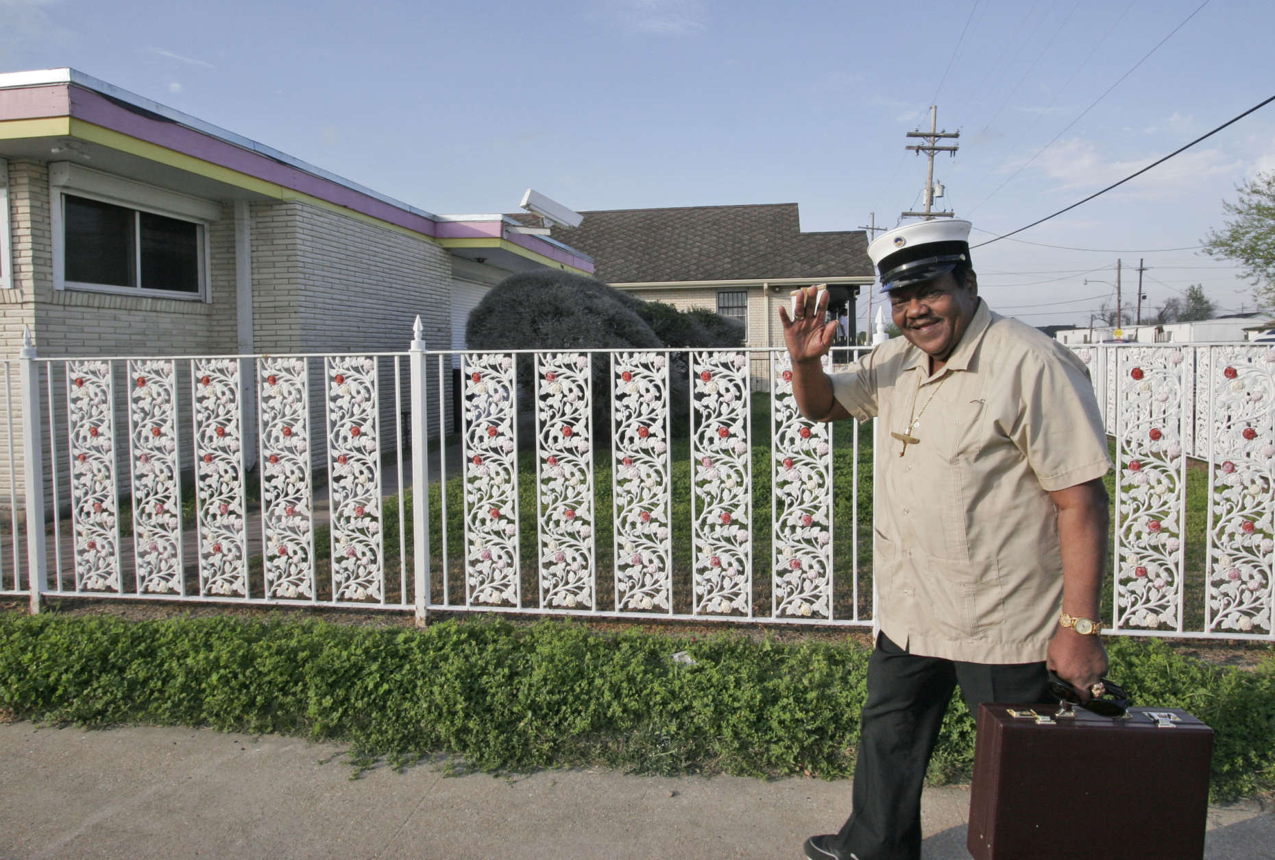World renowned musician Fats Domino waves as he leaves after checking the progress of the rebuilding of his home in the Lower Ninth Ward of New Orleans Friday, March 9, 2007.(AP Photo/Alex Brandon)