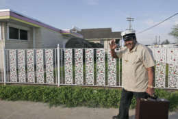 World renowned musician Fats Domino waves as he leaves after checking the progress of the rebuilding of his home in the Lower Ninth Ward of New Orleans Friday, March 9, 2007.(AP Photo/Alex Brandon)