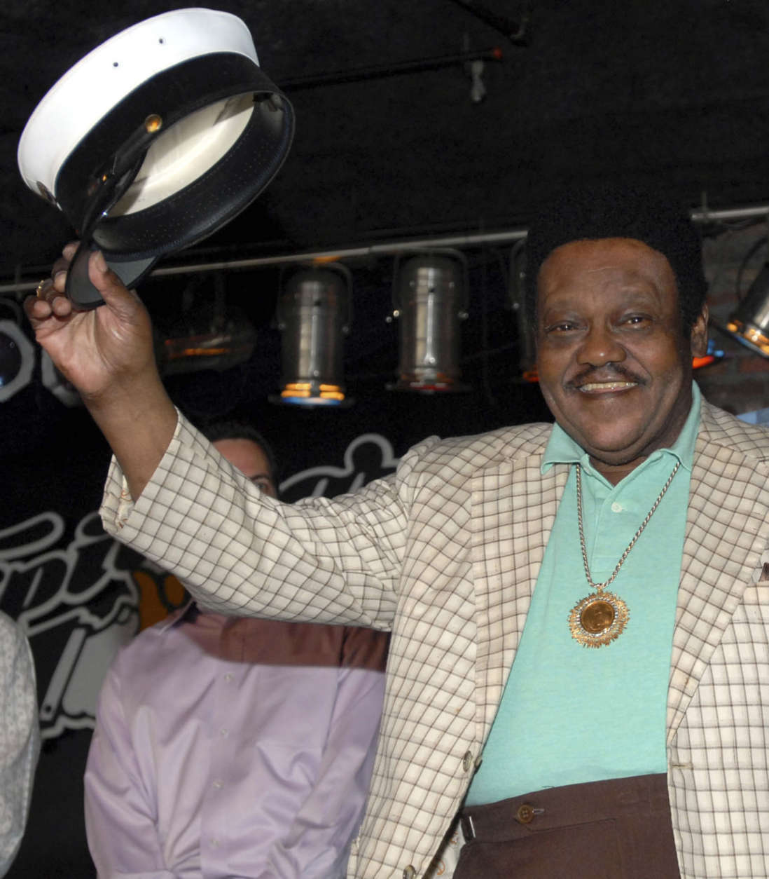 **RECROPPED TRANSMISSION OF LACG103**New Orleans rock 'n' roll performer Fats Domino waves to fans after he received a custom musical career and legacy award by the Recording Industry Association of America and was presented with 20 reproduced sales awards by Capitol/EMI replacing ones that he lost to Hurricane Katrina, in New Orleans on Monday, Aug. 13, 2007. (AP Photo/Cheryl Gerber)