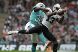 New Orleans Saints wide receiver Michael Thomas (13) catches a pass in front of Miami Dolphins cornerback Cordrea Tankersley (30) during the first half of an NFL football game at Wembley Stadium in London, Sunday Oct. 1, 2017. (AP Photo/Matt Dunham)
