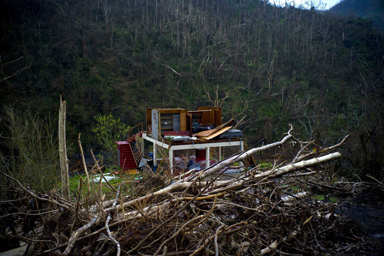 In this Saturday, Sept. 30, 2017 photo, the foundation of a heavily damaged house stands in the mountains after the passing of Hurricane Maria in the San Lorenzo neighborhood of Morovis, Puerto Rico. FEMA chief Brock Long said the agency has worked to fix roads, establish emergency power and deliver fuel to hospitals. He said telecommunications are available to about one-third of the island. (AP Photo/Ramon Espinosa)