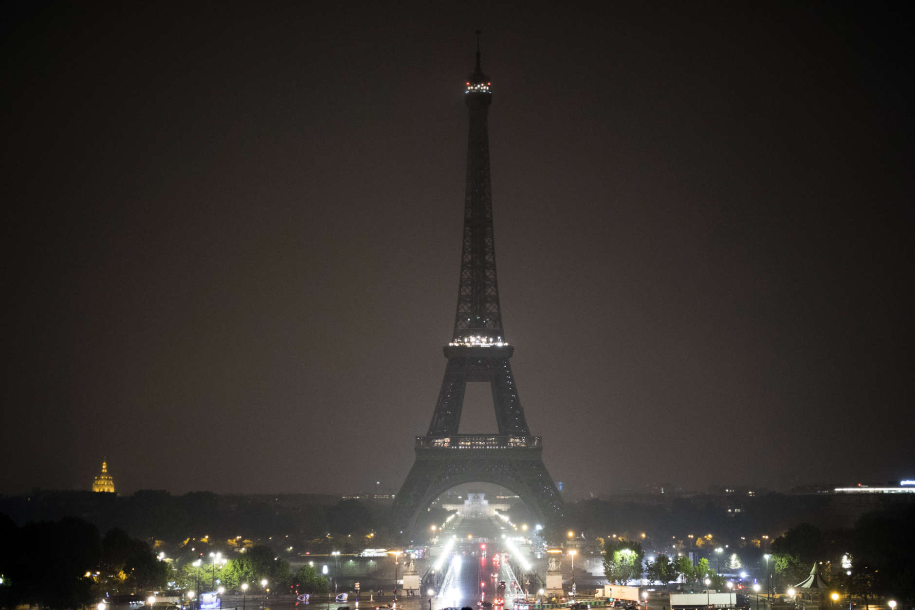 The Eiffel tower is seen with its lights turned off in Paris, France, Monday, Oct. 2, 2017. Paris mayor Anne Hidalgo said the Eiffel tower will turn off its lights Monday at midnight Paris hour to pay tribute to Las Vegas and Marseille victims. (AP Photo/Kamil Zihnioglu)