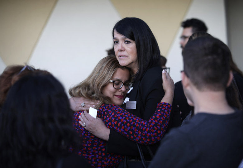 Maritza Rodriguez, right, embraces Emily Zamora after a special service at Guardian Angel Cathedral for the mass shooting on the Las Vegas Strip, Monday, Oct. 2, 2017, in Las Vegas. (AP Photo/John Locher)