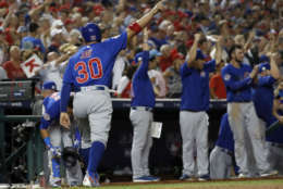 Chicago Cubs' Jon Jay (30) celebrates scoring on a double by Anthony Rizzo during the eighth inning Game 1 of baseball's National League Division Series against the Washington Nationals, at Nationals Park, Friday, Oct. 6, 2017, in Washington. (AP Photo/Alex Brandon)