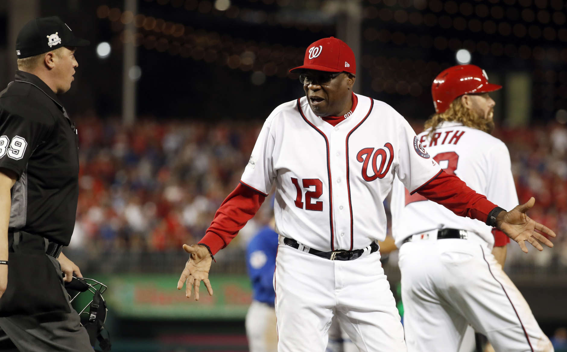 Washington Nationals manager Dusty Baker (12) argues a call of an out on Ryan Zimmerman with home plate umpire Cory Blaser, left, during Game 1 of baseball's National League Division Series against the Chicago Cubs, at Nationals Park, Friday, Oct. 6, 2017, in Washington. The Cubs won 3-0. (AP Photo/Alex Brandon)