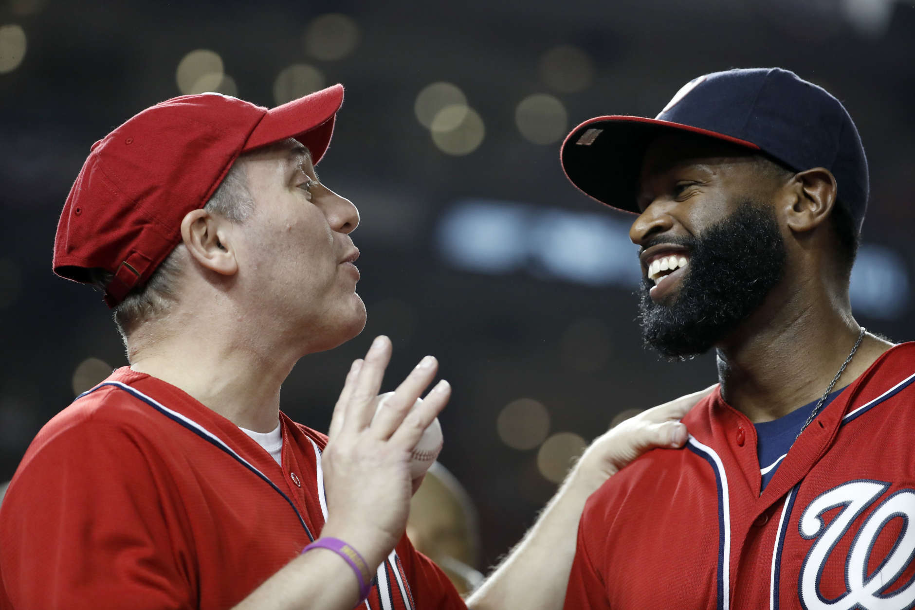 House Majority Whip Steve Scalise, left, R-La., talks with Capitol Hill Police Officer David Bailey, before throwing out a ceremonial first pitch before Game 1 of baseball's National League Division Series between the Washington Nationals and the Chicago Cubs, at Nationals Park, Friday, Oct. 6, 2017, in Washington. Bailey was wounded along with Scalise three months ago at a baseball practice shooting. (AP Photo/Alex Brandon)