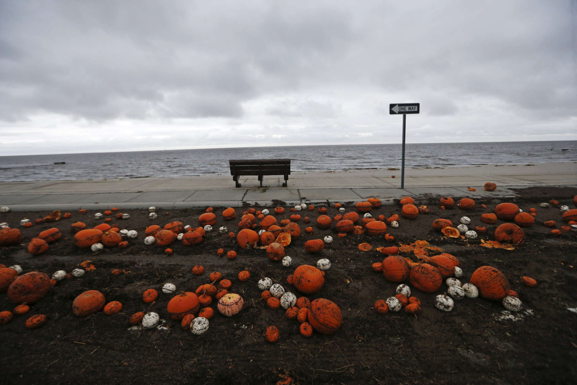 Pumpkins are strewn along the Gulf of Mexico in Pass Christian, Miss., in the aftermath of Hurricane Nate, Sunday, Oct. 8, 2017. (AP Photo/Gerald Herbert)