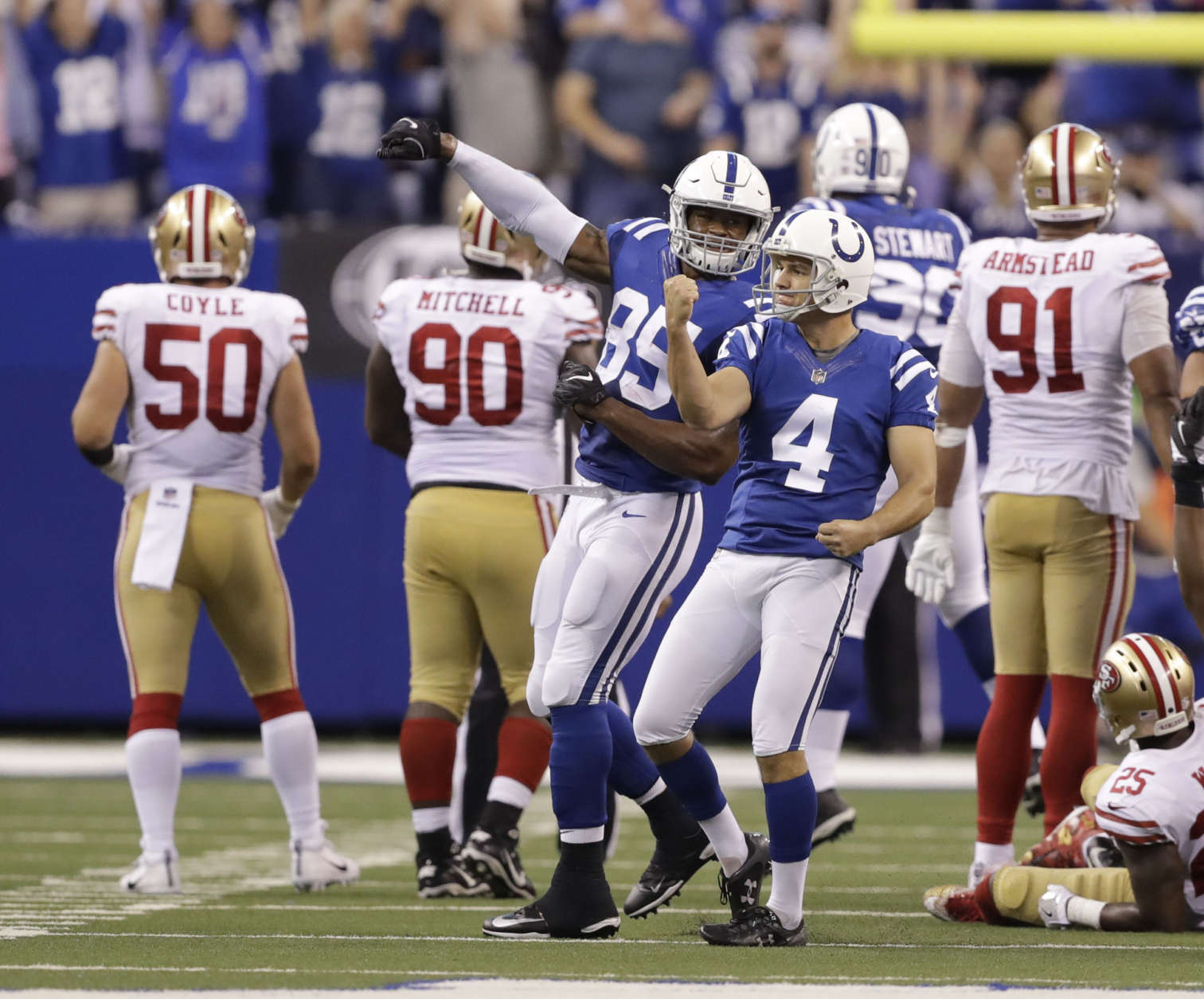 Indianapolis Colts' Adam Vinatieri (4) celebrates after kicking the game winning 51-yard field goal out of the hold of Rigoberto Sanchez (2) during overtime of an NFL football game against the San Francisco 49ers, Sunday, Oct. 8, 2017, in Indianapolis. Indianapolis won 26-23. (AP Photo/Darron Cummings)