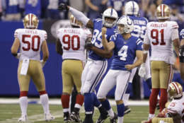 Indianapolis Colts' Adam Vinatieri (4) celebrates after kicking the game winning 51-yard field goal out of the hold of Rigoberto Sanchez (2) during overtime of an NFL football game against the San Francisco 49ers, Sunday, Oct. 8, 2017, in Indianapolis. Indianapolis won 26-23. (AP Photo/Darron Cummings)