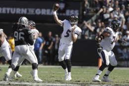 Baltimore Ravens quarterback Joe Flacco (5) passes against the Oakland Raiders during the first half of an NFL football game in Oakland, Calif., Sunday, Oct. 8, 2017. (AP Photo/Marcio Jose Sanchez)