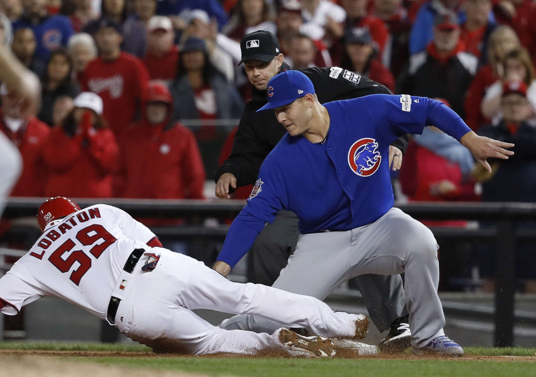 Chicago Cubs first baseman Anthony Rizzo (44) picks off Washington Nationals' Jose Lobaton on a throw from catcher Willson Contreras during the eighth inning in Game 5 of baseball's National League Division Series against the Chicago Cubs, at Nationals Park, early Friday, Oct. 13, 2017, in Washington. The Cubs challenged the call on the field and it was overturned on review. (AP Photo/Pablo Martinez Monsivais)