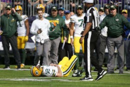 Green Bay Packers quarterback Aaron Rodgers (12) lies on the ground after being hit by Minnesota Vikings outside linebacker Anthony Barr (55) in the first half of an NFL football game in Minneapolis, Sunday, Oct. 15, 2017. (AP Photo/Bruce Kluckhohn)