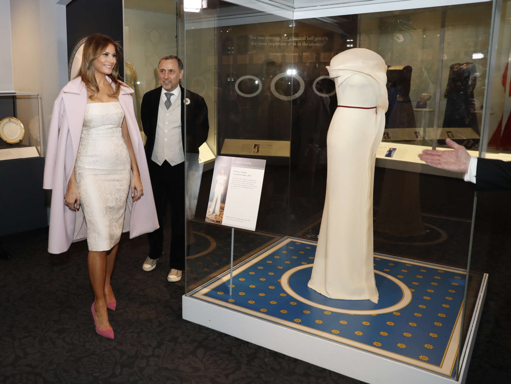 First lady Melania Trump donates her inaugural gown, designed by Hervé Pierre, center, to the First Ladies' Collection at the Smithsonian's National Museum of American History, during a ceremony in Washington, Friday, Oct. 20, 2017. (AP Photo/Pablo Martinez Monsivais)
