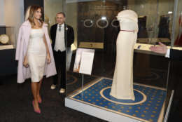 First lady Melania Trump donates her inaugural gown, designed by Hervé Pierre, center, to the First Ladies' Collection at the Smithsonian's National Museum of American History, during a ceremony in Washington, Friday, Oct. 20, 2017. (AP Photo/Pablo Martinez Monsivais)