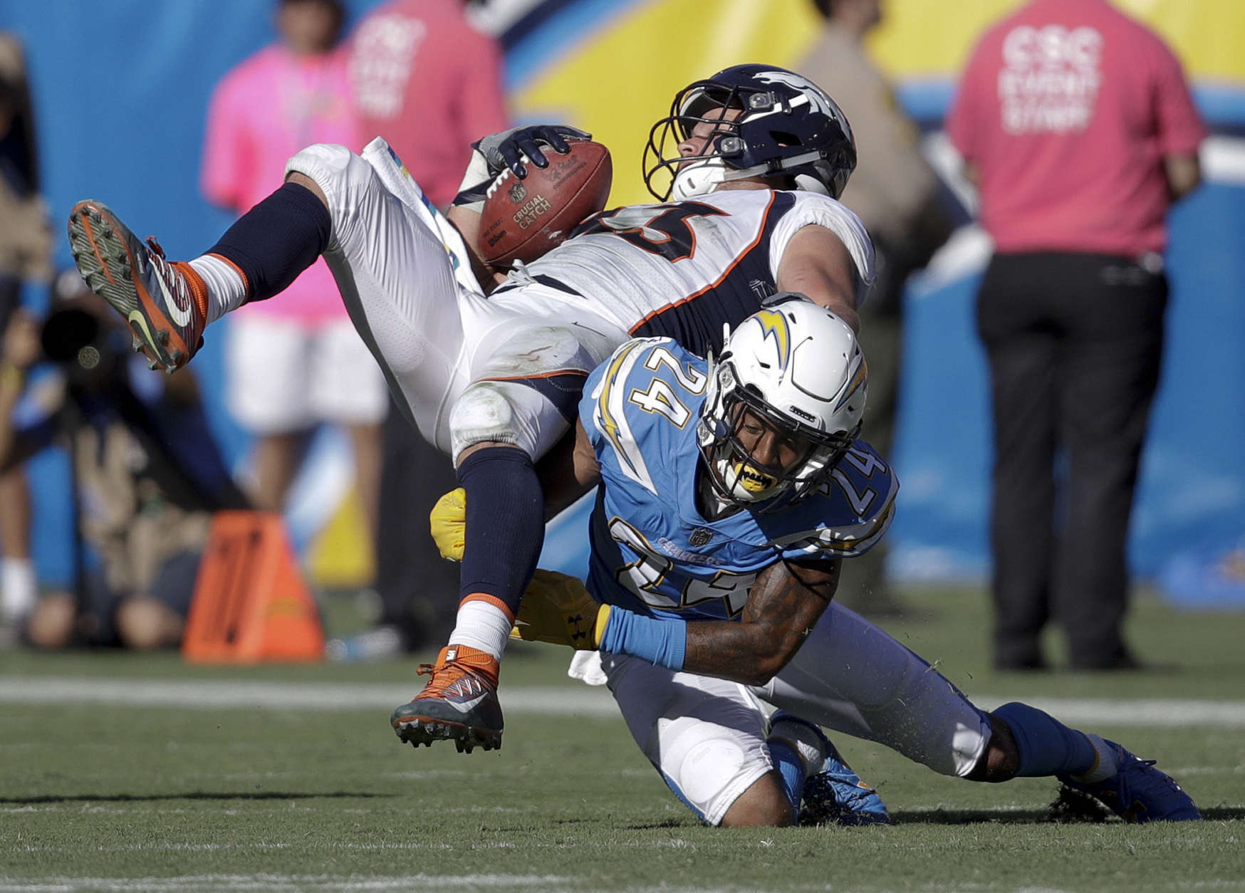 Denver Broncos tight end A.J. Derby, top, is tackled by Los Angeles Chargers cornerback Trevor Williams during the second half of an NFL football game Sunday, Oct. 22, 2017, in Carson, Calif. (AP Photo/Jae C. Hong)