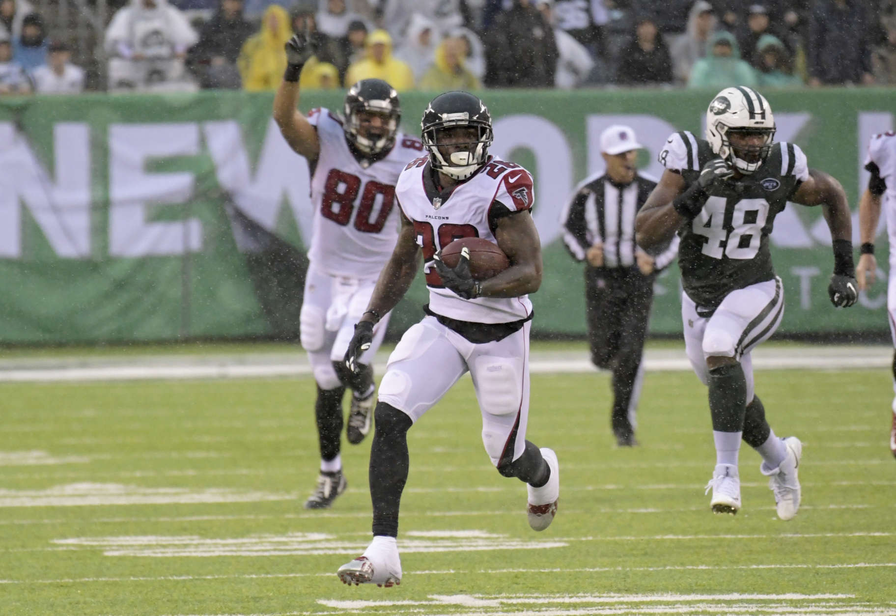 Atlanta Falcons running back Tevin Coleman (26) is pursued by New York Jets outside linebacker Jordan Jenkins (48) during the second half of an NFL football game against the New York Jets Sunday, Oct. 29, 2017, in East Rutherford, N.J. (AP Photo/Bill Kostroun)