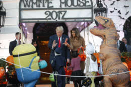 President Donald Trump and first lady Melania Trump hand out treats as they welcome children from the Washington area and children of military families to trick-or-treat celebrating Halloween at the South Lawn of the White House in Washington, Monday, Oct. 30, 2017. (AP Photo/Pablo Martinez Monsivais)