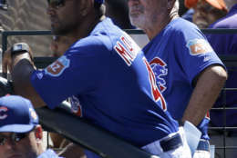 Chicago Cubs bench coach Dave Martinez, left, and manager Joe Maddon watch during a spring training baseball game between the Cubs and the San Francisco Giants in Mesa, Ariz., Saturday, March 26, 2016. (AP Photo/Jeff Chiu)