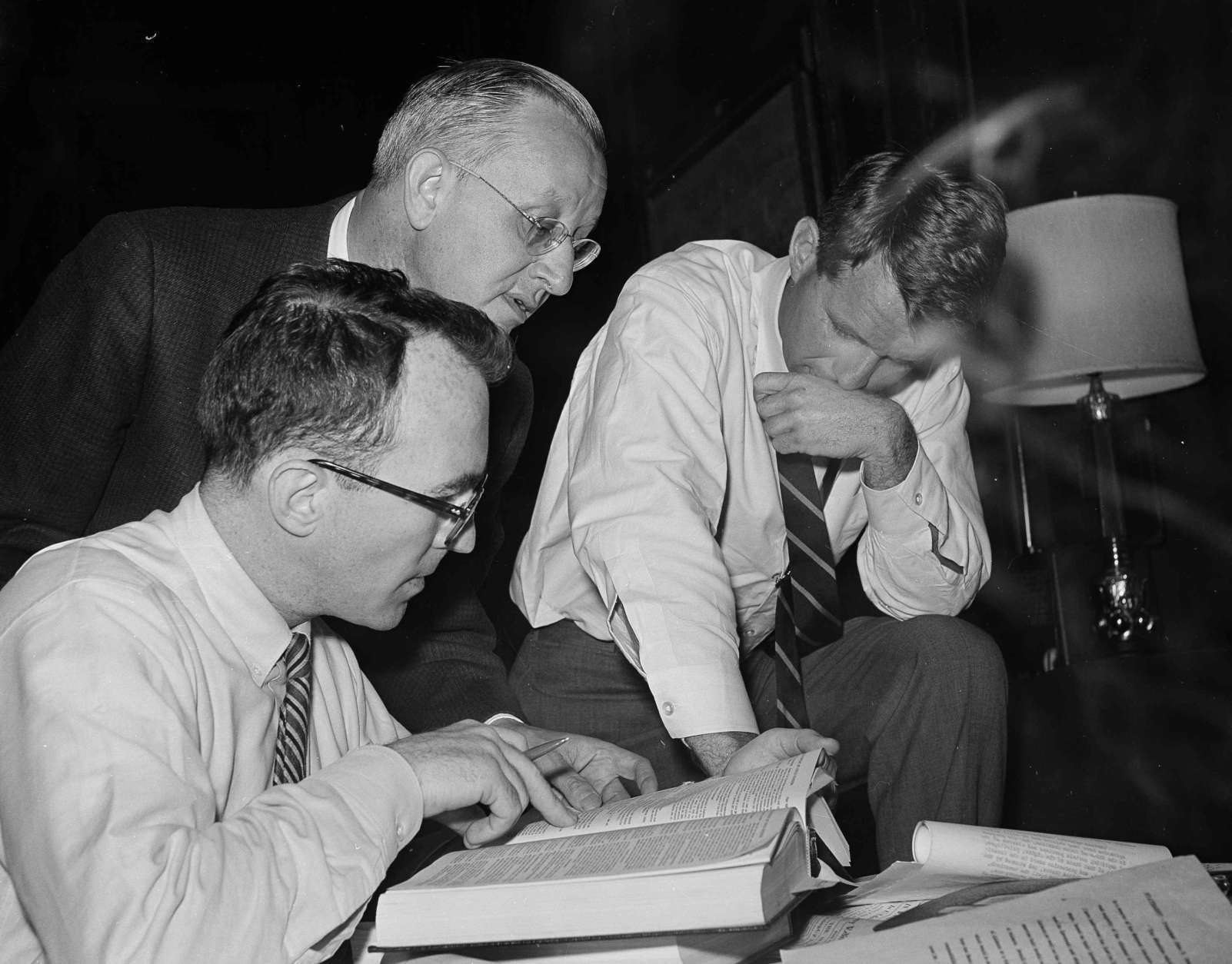 Attorney General Robert F. Kennedy, right, watches as Assistant Deputy Attorney General William Geoghegan, seated, looks up a point of law on the use of U.S. Marshal assisted by Leon William, of Kennedys office of legal counsel at the Justice Department, May 21, 1961, Washington, D.C. The attorney general ordered a task force of U.S. Marshal to Montgomery, Ala., where the arrival of a busload of white and African American youths touched off racial violence on May 20. (AP Photo/Byron Rollins)