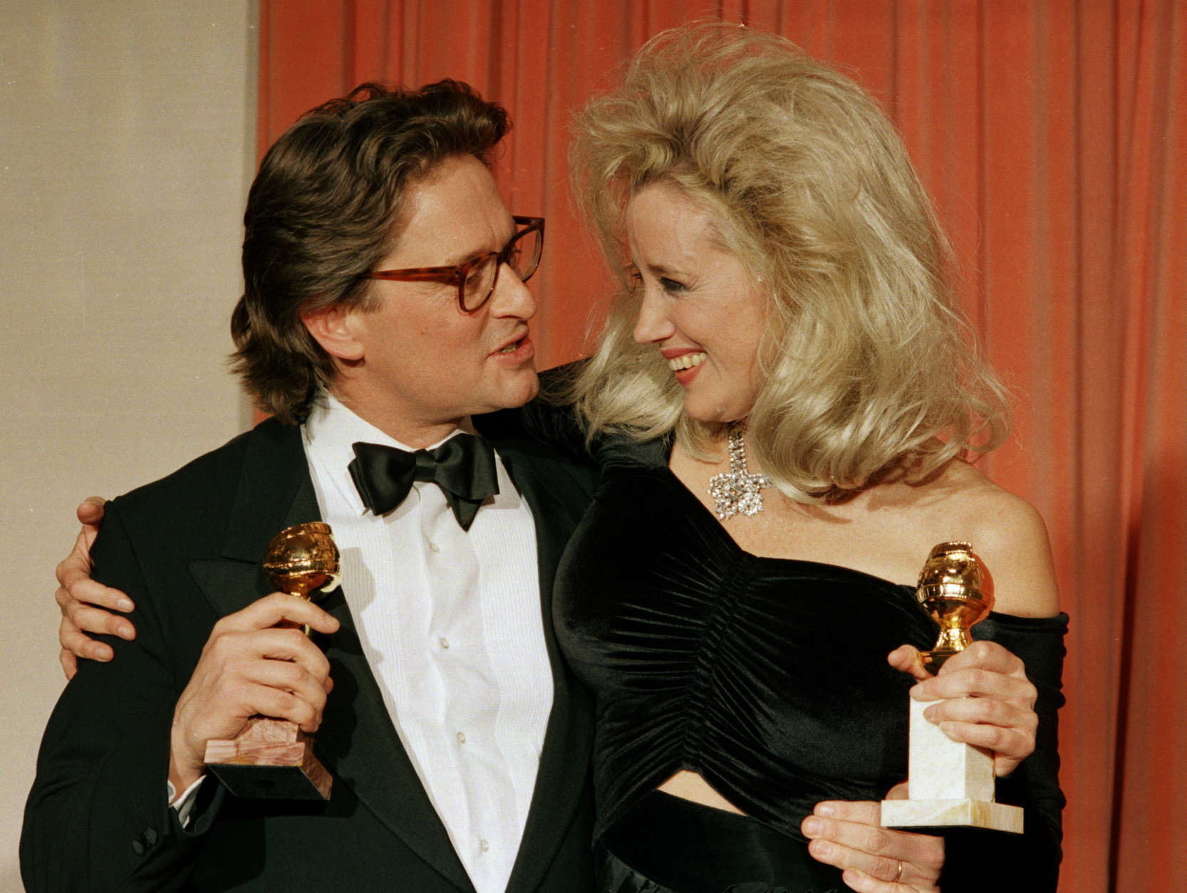 Michael Douglas, left, and Sally Kirkland congratulate each other backstage at the Beverly Hilton Hotel after winning awards at the 45th Annual Golden Globe Awards presentations in Beverly Hills, Ca., Jan. 24, 1988.  Douglas won best actor for his role in "Wall Street" and Kirkland won best actress for her role in "Anna."  (AP Photo/Reed Saxon)