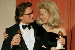 Michael Douglas, left, and Sally Kirkland congratulate each other backstage at the Beverly Hilton Hotel after winning awards at the 45th Annual Golden Globe Awards presentations in Beverly Hills, Ca., Jan. 24, 1988.  Douglas won best actor for his role in "Wall Street" and Kirkland won best actress for her role in "Anna."  (AP Photo/Reed Saxon)