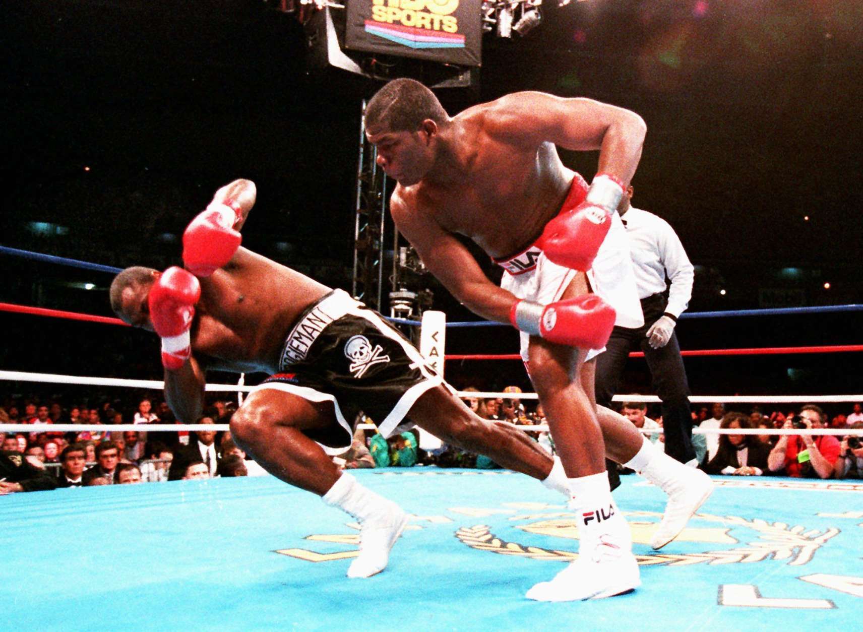 Heavyweight champion Riddick Bowe knocks down Jesse Ferguson during the WBA and IBF championship fight, May 22, 1993. (AP Photo/Marc Wilson)