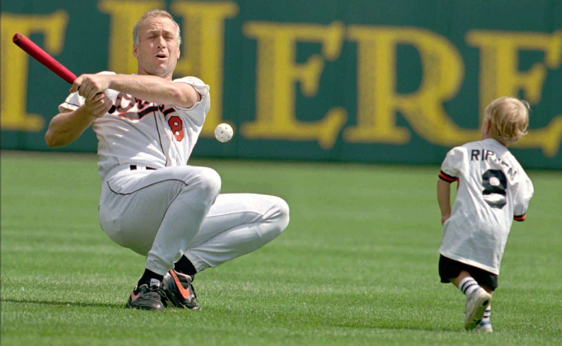 Baltimore Orioles Cal Ripken swings, misses and tumbles to the ground as his son Ryan pitches to him during Orioles Family Day at Camden yards in Baltimore Sunday, Sept. 3, 1995.(AP Photo/Roberto Borea)