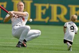 Baltimore Orioles Cal Ripken swings, misses and tumbles to the ground as his son Ryan pitches to him during Orioles Family Day at Camden yards in Baltimore Sunday, Sept. 3, 1995.(AP Photo/Roberto Borea)