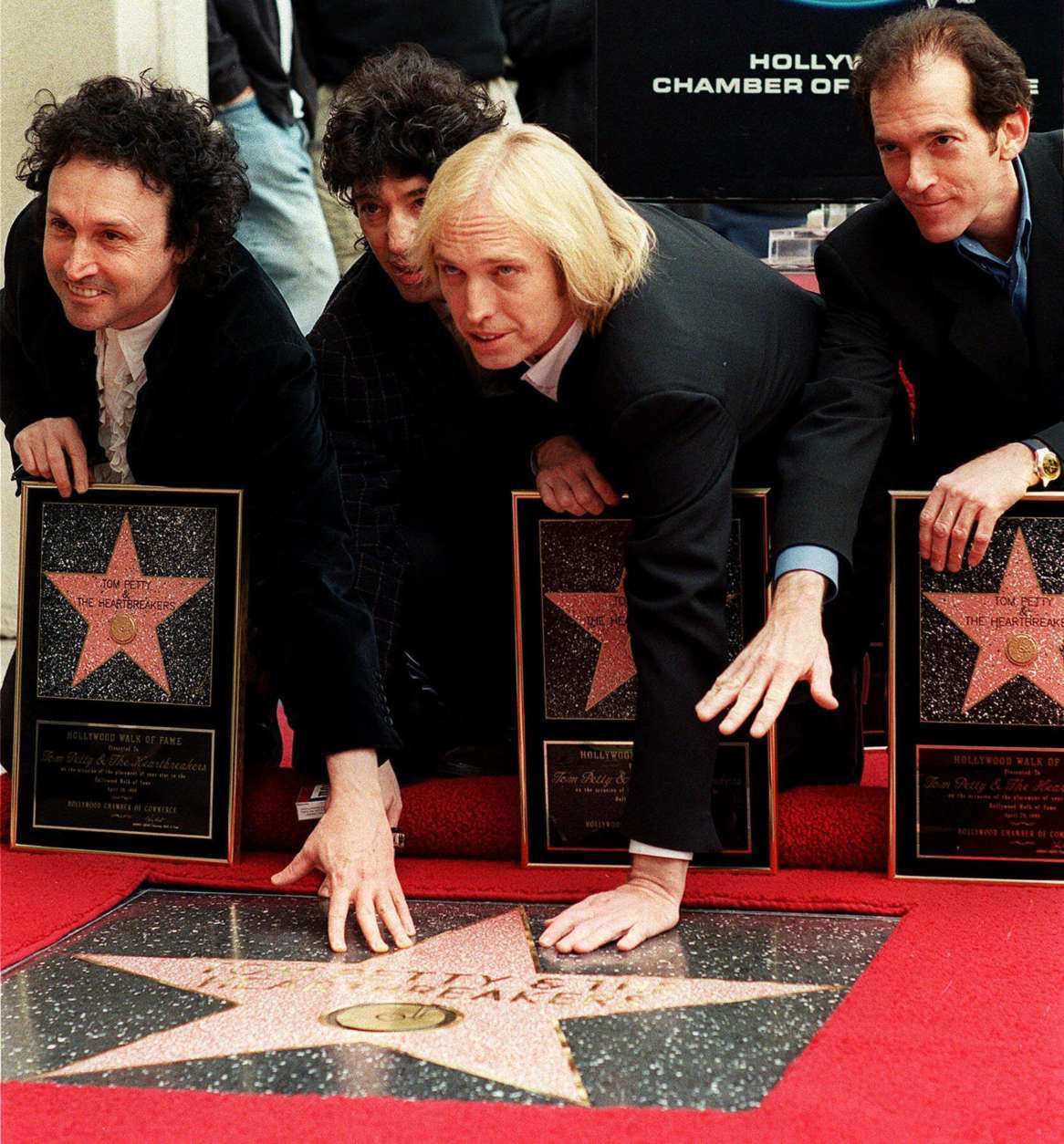 Tom Petty and the Heartbreakers rock band members, left to right: Mike Campbell, Howie Epstein, Tom Petty and Benmont Tench pose for a photo, as they are honored Wednesday, April 28, 1999, with the 2,133rd star on the Hollywood Walk of Fame in the Hollywood section of Los Angeles.  Tom Petty and the Heartbreakers have sold over 30 million albums, won Grammys and MTV awards and produced over 25 classic hits. Their latest album " Echo" which was released on April 13th debuted this week at number 10 on the Billboard album chart. (AP Photo/Damian Dovarganes)