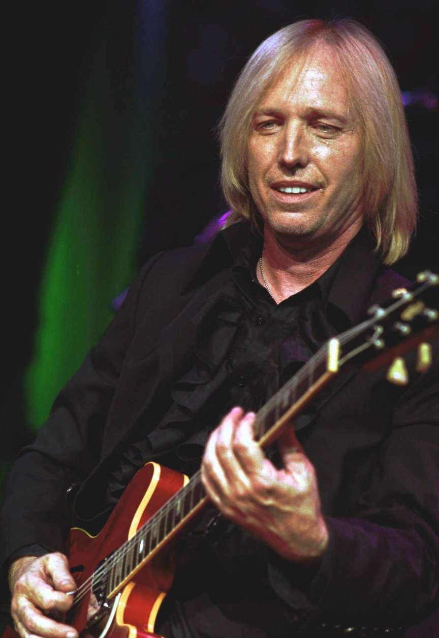 Tom Petty puts his band The Heartbreakers through their paces during a concert Friday, June 18, 1999, at Pine Knob Music Theater in Clarkston, Mich.  Petty and The Heartbreakers launched their  current U.S. tour earlier this week in Grand Rapids, Mich. (AP Photo/Paul Warner)