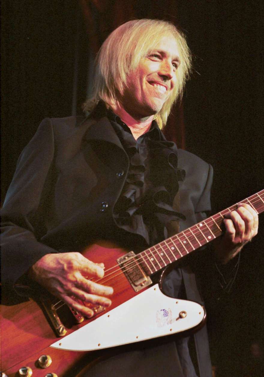 Tom Petty puts his band The Heartbreakers through their paces during their concert Friday, June 18, 1999 at Pine Knob Music Theater in Clarkston, Mich.  Petty and the Heartbreakers launched their current U.S. tour earlier this week in Grand Rapids, Mich. (AP Photo/Paul Warner)