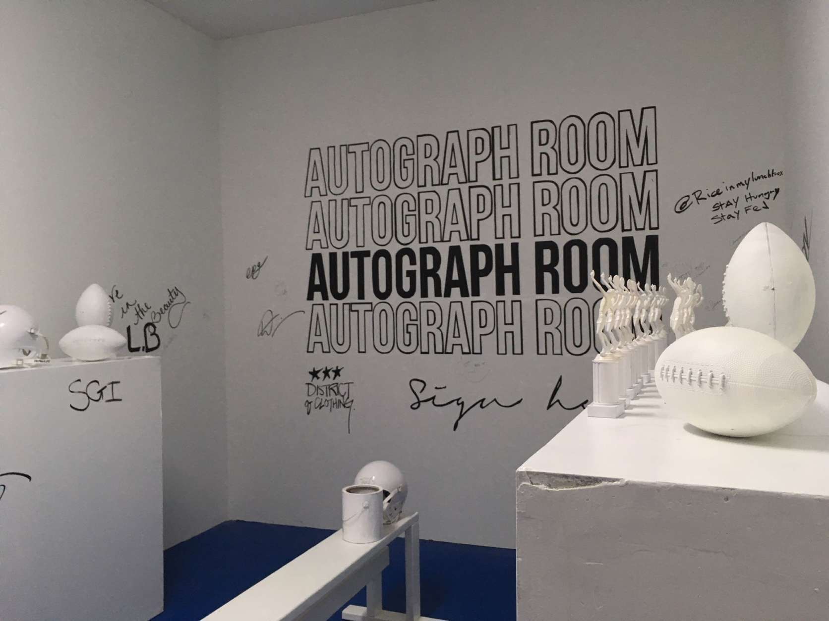 The autograph room gives visitors a chance to leave their mark, literally, with lockers, equipment and walls all available to sign. (WTOP/Noah Frank)