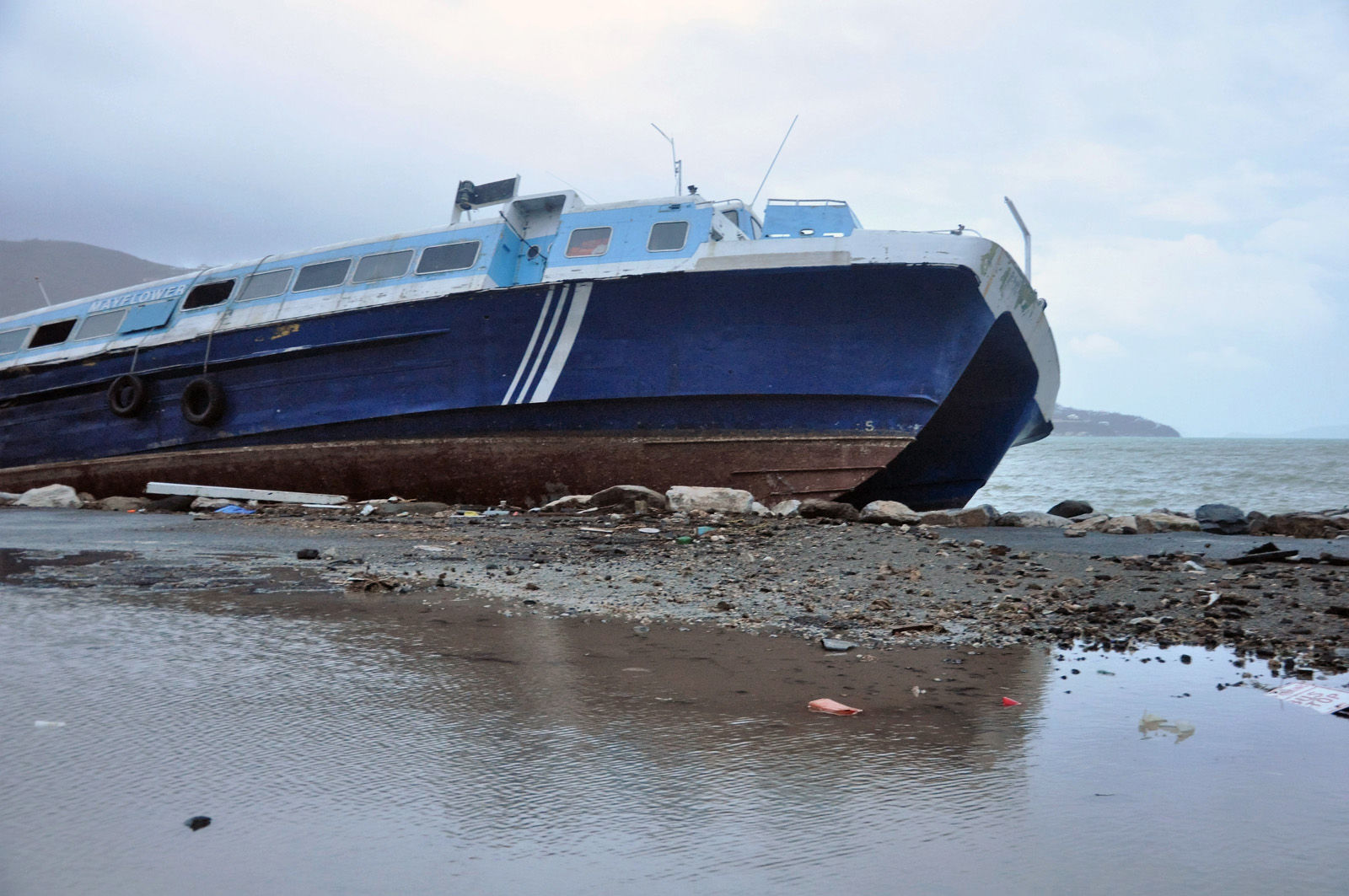 A ferry beached last week by Hurricane Irma in Road Town, Tortola, the capital of the British Virgin Islands, remained unmoved after Hurricane Maria passed, early Wednesday, Sept. 20, 2017. (AP Photo/Freeman Rogers)