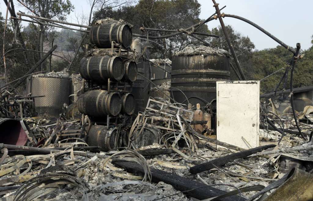 Damage to wine making vats and barrels at the production house of Paradise Ridge Winery from a wildfire are seen on Tuesday, Oct. 10, 2017 in Santa Rosa, Calif. An onslaught of wildfires across a wide swath of Northern California broke out almost simultaneously then grew exponentially, swallowing up properties from wineries to trailer parks and tearing through both tiny rural towns and urban subdivisions. (AP Photo/Ben Margot)
