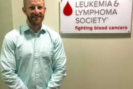 A picture of of Vincent Carrano in front of the Leukemia &amp; Lymphoma Society sign on his first day of work for the organization on April 18, 2016. (Courtesy Vincent Carrano)