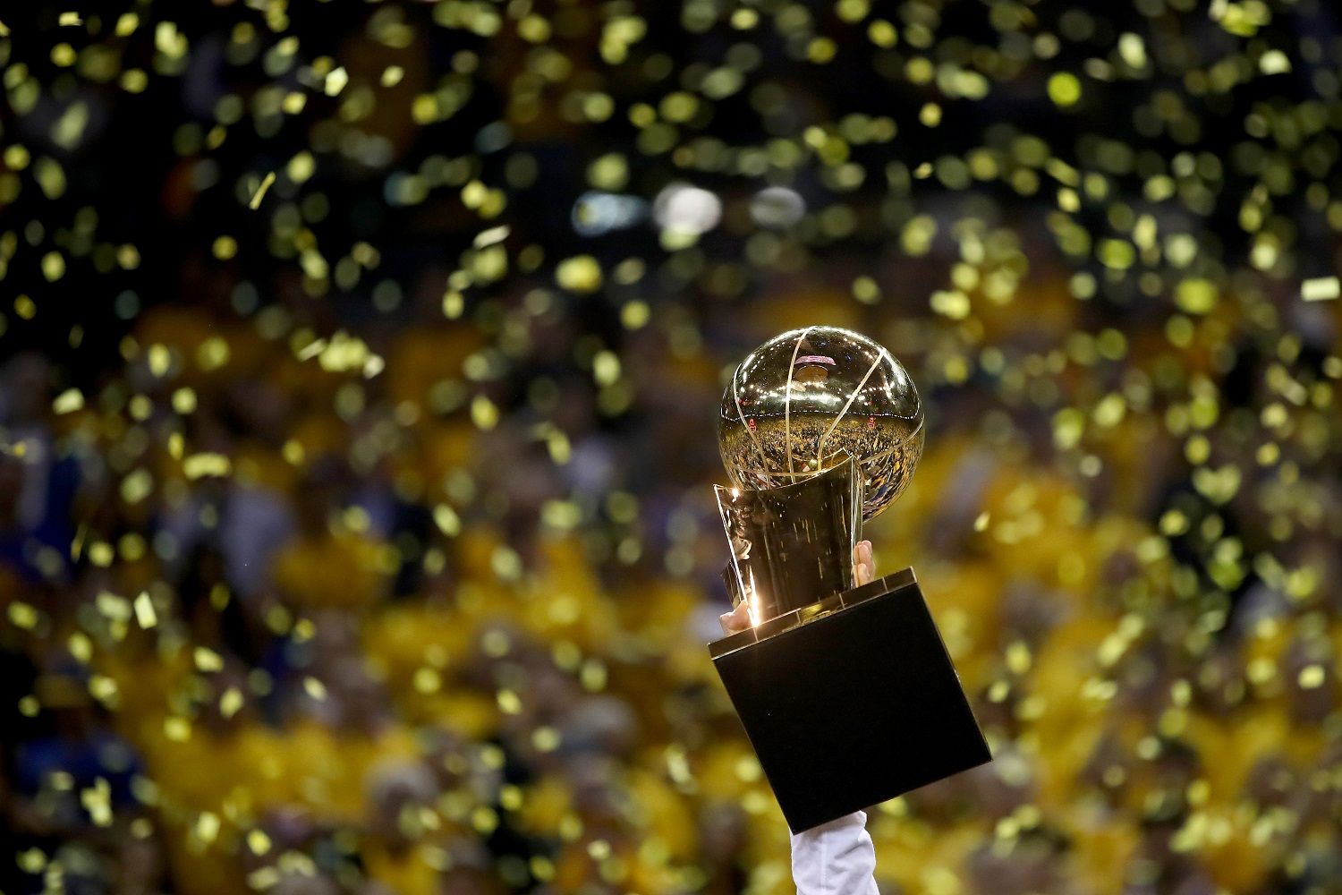 OAKLAND, CA - JUNE 12:  The Larry O'Brien Championship Trophy is held following the Golden State Warriors 129-120 win over the Cleveland Cavaliers in Game 5 to win the 2017 NBA Finals at ORACLE Arena on June 12, 2017 in Oakland, California. NOTE TO USER: User expressly acknowledges and agrees that, by downloading and or using this photograph, User is consenting to the terms and conditions of the Getty Images License Agreement.  (Photo by Ezra Shaw/Getty Images)
