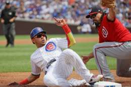 CHICAGO, IL - AUGUST 05:   Willson Contreras #40 of the Chicago Cubs is tagged out at third base by Anthony Rendon #6 of the Washington Nationals in the 1st inning at Wrigley Field on August 5, 2017 in Chicago, Illinois. (Photo by Jonathan Daniel/Getty Images)
