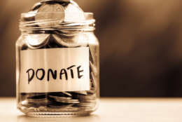 Picture shows a jar of coins with the label donate