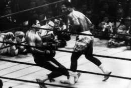 March 1971:  In a title fight at Madison Square Gardens, New York, Muhammad Ali goes down in the 15th round to a left hook from world heavyweight champion Joe Frazier who kept the title with an unanimous points win. Cameramen are crowded round the ring.  (Photo by Keystone/Getty Images)